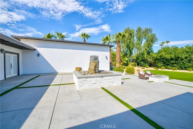 72408 Desert Dr, Rancho Mirage, CA 92270 - view of patio with an outdoor fire pit and french doors