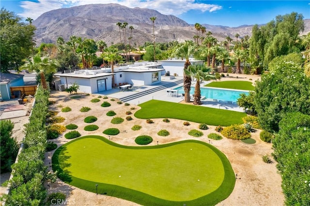 72408 Desert Dr, Rancho Mirage, CA 92270 - surrounding community with a putting area, a mountain view, and a swimming pool