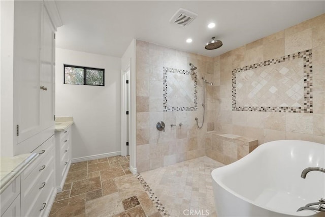 72408 Desert Dr, Rancho Mirage, CA 92270 - full bath featuring a freestanding tub, vanity, tiled shower, stone tile floors, and recessed lighting