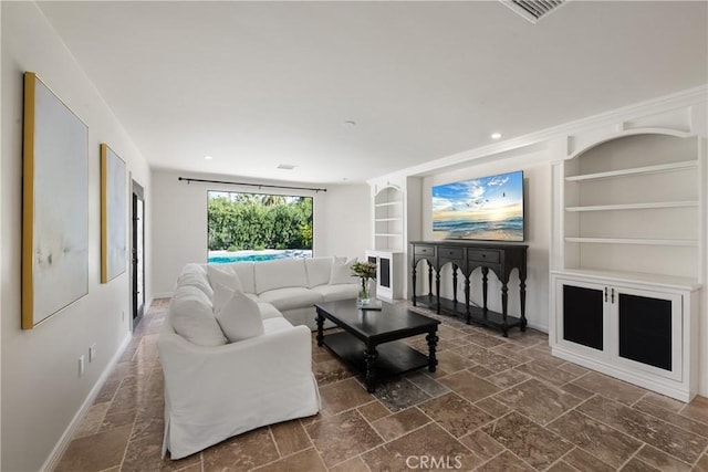 72408 Desert Dr, Rancho Mirage, CA 92270 - living room with built in shelves, baseboards, stone tile floors, and recessed lighting