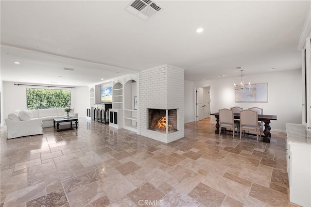 72408 Desert Dr, Rancho Mirage, CA 92270 - living room featuring stone tile flooring, built in shelves, a chandelier, recessed lighting, and a fireplace