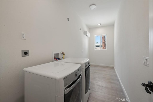 72408 Desert Dr, Rancho Mirage, CA 92270 - laundry room with a wall mounted AC, light wood-style flooring, baseboards, and washing machine and dryer