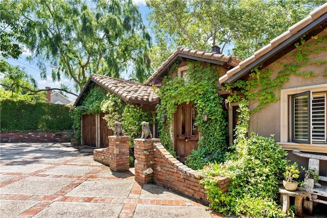 302 W Carter Ave, Sierra Madre, CA 91024 - view of front of home featuring a garage, concrete driveway, and a tiled roof