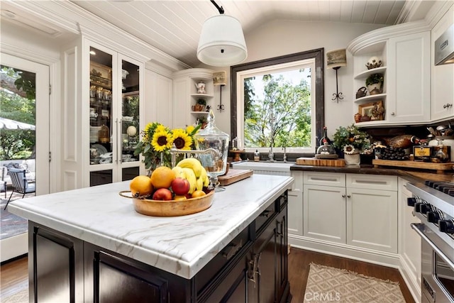302 W Carter Ave, Sierra Madre, CA 91024 - kitchen featuring open shelves, stainless steel stove, dark wood finished floors, white cabinets, and lofted ceiling