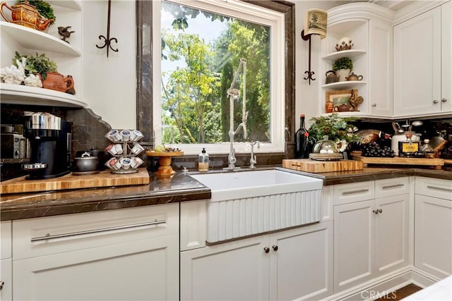 302 W Carter Ave, Sierra Madre, CA 91024 - kitchen with open shelves, a sink, dark countertops, and white cabinetry