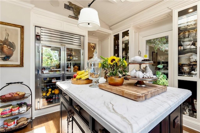 302 W Carter Ave, Sierra Madre, CA 91024 - kitchen featuring dark wood-style floors, stainless steel built in fridge, hanging light fixtures, ornamental molding, and light stone counters