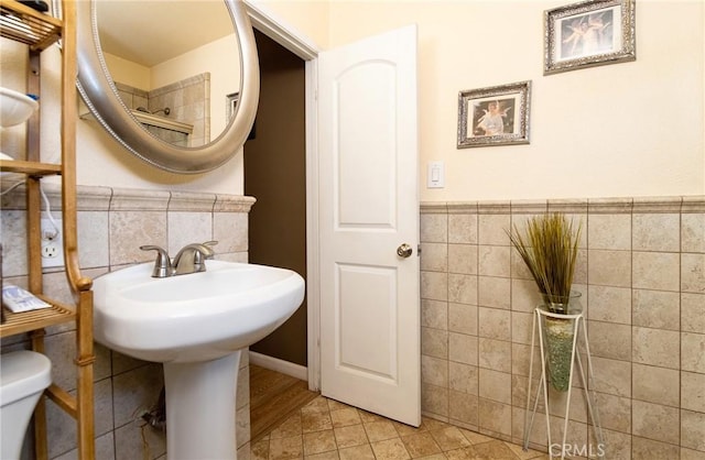 900 E Sagebank St, Carson, CA 90746 - bathroom with tile walls, toilet, a wainscoted wall, and tile patterned floors