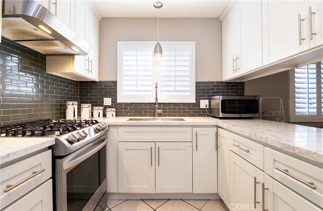 900 E Sagebank St, Carson, CA 90746 - kitchen with stainless steel appliances, ventilation hood, a sink, white cabinetry, and tasteful backsplash
