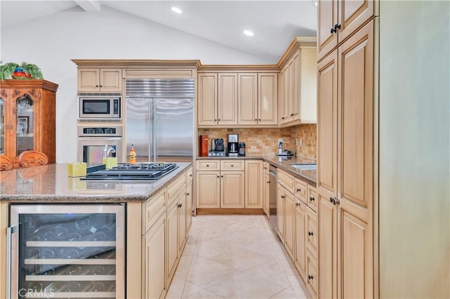 724 S Broadway Unit B, Redondo Beach, CA 90277 - kitchen with beverage cooler, built in appliances, vaulted ceiling, decorative backsplash, and light stone countertops