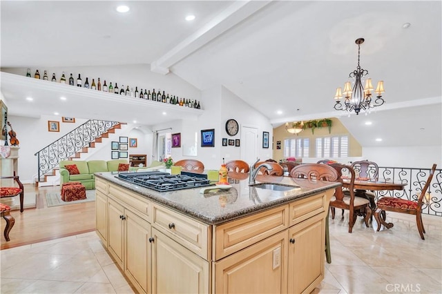 724 S Broadway Unit B, Redondo Beach, CA 90277 - kitchen with a sink, black gas cooktop, open floor plan, a kitchen island with sink, and a chandelier