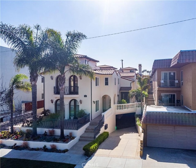 724 S Broadway Unit B, Redondo Beach, CA 90277 - mediterranean / spanish house with concrete driveway, a garage, stucco siding, a balcony, and a residential view