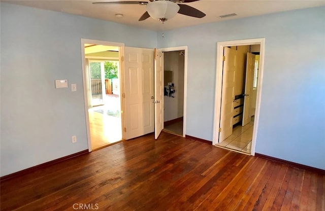 3513 Denker Ave, Los Angeles, CA 90018 - unfurnished bedroom featuring dark wood-style floors, baseboards, and ceiling fan