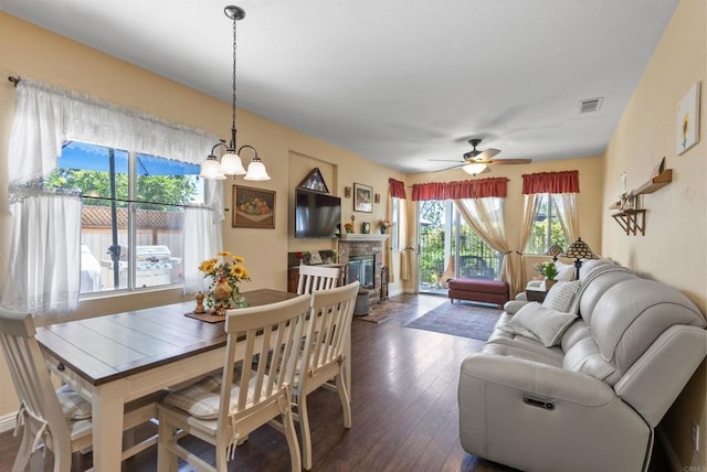 31081 Bunker Dr, Temecula, CA 92591 - dining area featuring dark wood-style flooring, a fireplace, and ceiling fan