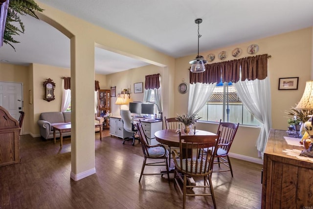 31081 Bunker Dr, Temecula, CA 92591 - dining room featuring dark wood-style flooring, baseboards, and arched walkways