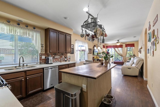 31081 Bunker Dr, Temecula, CA 92591 - kitchen featuring stainless steel dishwasher, a sink, healthy amount of natural light, and dark wood-type flooring