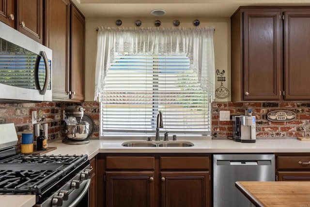 31081 Bunker Dr, Temecula, CA 92591 - kitchen with appliances with stainless steel finishes, a sink, light countertops, and backsplash