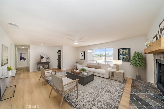 28732 Paseo Diablo, Menifee, CA 92587 - living area featuring a fireplace with flush hearth, a ceiling fan, and light wood-type flooring