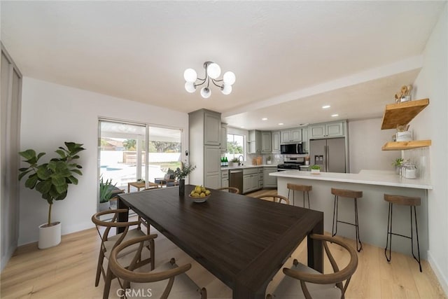 28732 Paseo Diablo, Menifee, CA 92587 - dining space with light wood-style flooring, a chandelier, recessed lighting, and baseboards