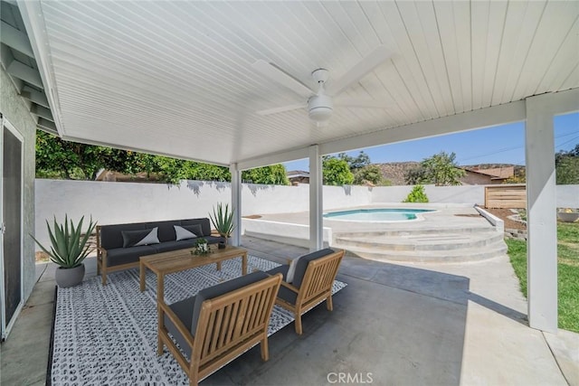 28732 Paseo Diablo, Menifee, CA 92587 - fenced backyard featuring a patio area, an in-ground hot tub, outdoor lounge area, and a ceiling fan