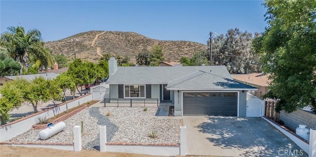 28732 Paseo Diablo, Menifee, CA 92587 - ranch-style home with a garage, a gate, driveway, and a mountain view
