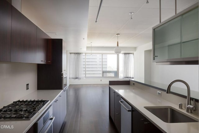 1155 S Grand Ave Unit 1403, Los Angeles, CA 90015 - kitchen featuring a sink, appliances with stainless steel finishes, dark wood-style flooring, light countertops, and hanging light fixtures