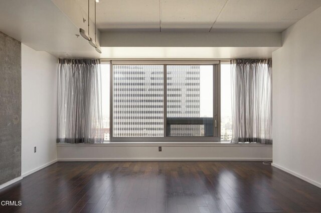 1155 S Grand Ave Unit 1403, Los Angeles, CA 90015 - unfurnished room featuring hardwood / wood-style flooring, healthy amount of natural light, and baseboards
