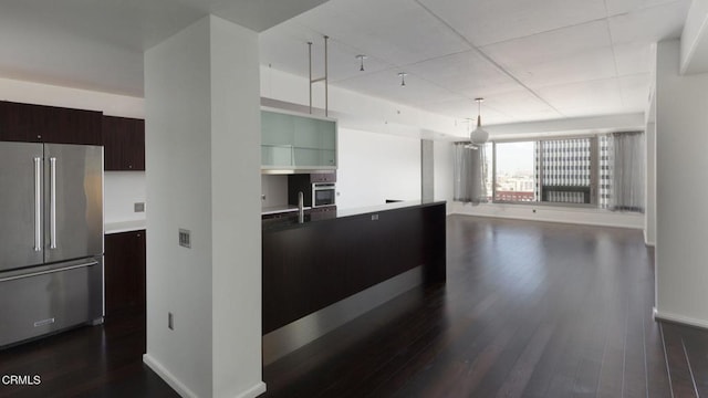 1155 S Grand Ave Unit 1403, Los Angeles, CA 90015 - kitchen with stainless steel appliances, dark wood finished floors, baseboards, dark brown cabinetry, and light countertops