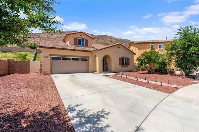 33007 Cattle Dr, Winchester, CA 92596 - mediterranean / spanish house with stucco siding, concrete driveway, a tiled roof, an attached garage, and a mountain view