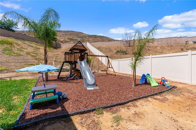 33007 Cattle Dr, Winchester, CA 92596 - view of playground with a fenced backyard and a mountain view
