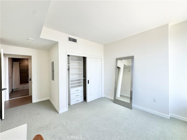1050 S Grand Ave Unit 2003, Los Angeles, CA 90015 - unfurnished bedroom featuring light carpet, a closet, baseboards, and electric panel