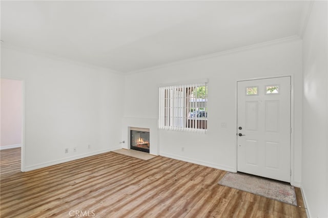 68 Via Terrano, Rancho Santa Margarita, CA 92688 - foyer with crown molding, wood finished floors, a fireplace with flush hearth, and baseboards
