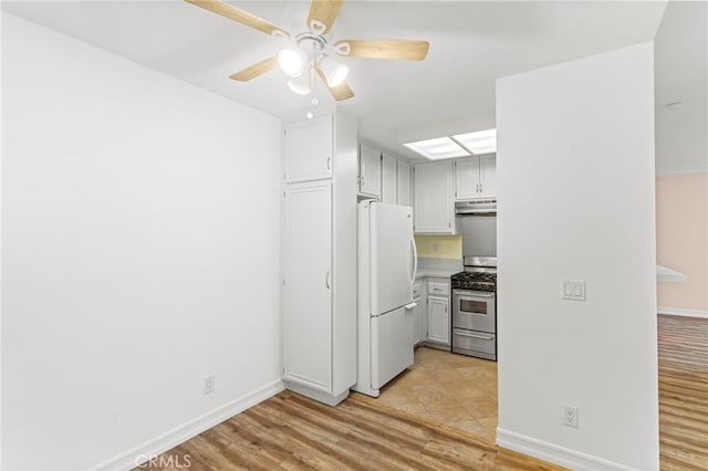 68 Via Terrano, Rancho Santa Margarita, CA 92688 - kitchen with stainless steel range with gas stovetop, freestanding refrigerator, under cabinet range hood, light wood finished floors, and a ceiling fan