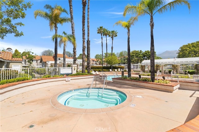 68 Via Terrano, Rancho Santa Margarita, CA 92688 - view of swimming pool featuring a hot tub, a residential view, and a mountain view