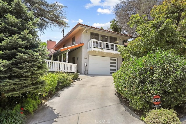 749 Canyon Crest Dr, Sierra Madre, CA 91024 - view of front of property with stucco siding, a tiled roof, driveway, a garage, and a chimney