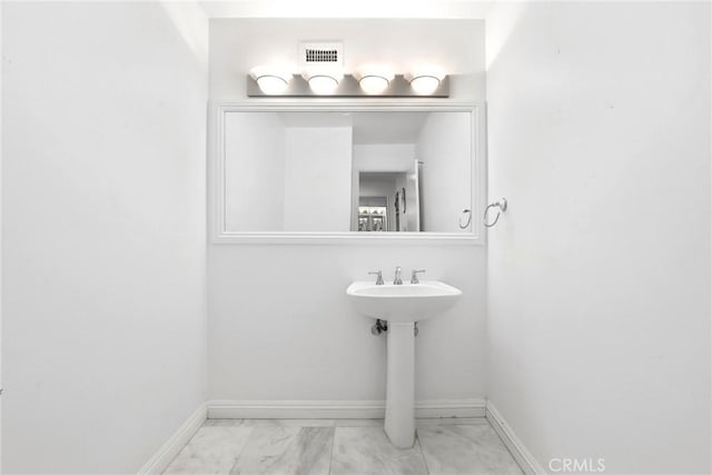 749 Canyon Crest Dr, Sierra Madre, CA 91024 - bathroom featuring marble look tiles and baseboards