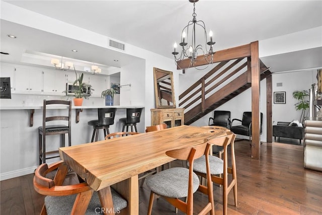 749 Canyon Crest Dr, Sierra Madre, CA 91024 - dining space featuring a chandelier, stairs, dark wood-type flooring, recessed lighting, and a tray ceiling