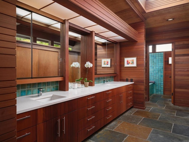 7226 Romero Dr, La Jolla, CA 92037 - bathroom with double vanity, wooden ceiling, stone tile flooring, decorative backsplash, and wood walls