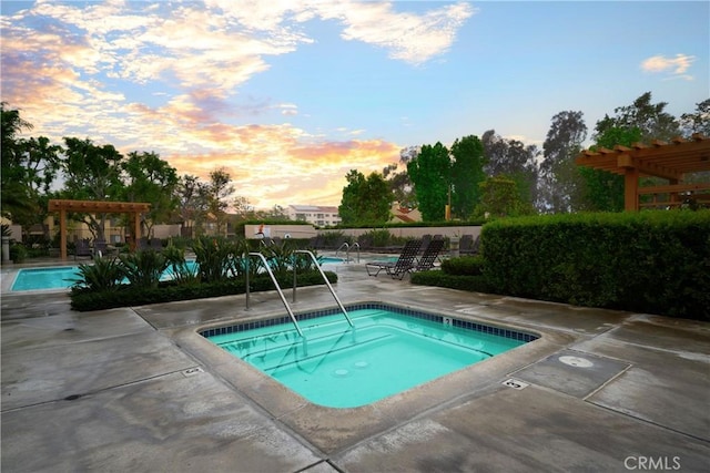 155 Oxford Unit 37, Irvine, CA 92612 - pool at dusk with a hot tub, a pergola, and a community pool