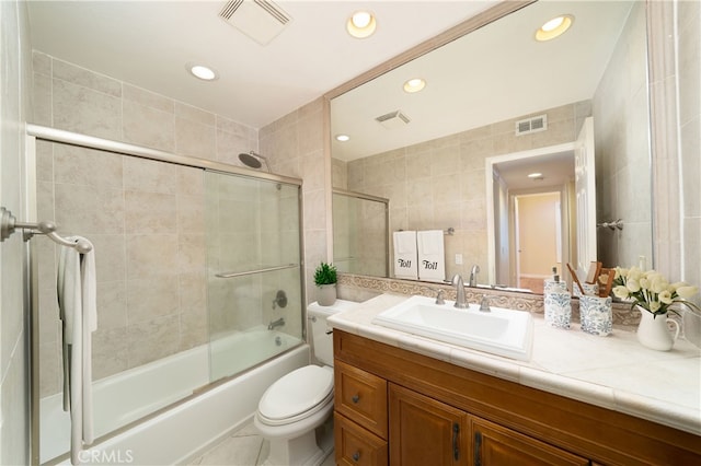 155 Oxford Unit 37, Irvine, CA 92612 - bathroom featuring vanity, tile walls, enclosed tub / shower combo, toilet, and recessed lighting