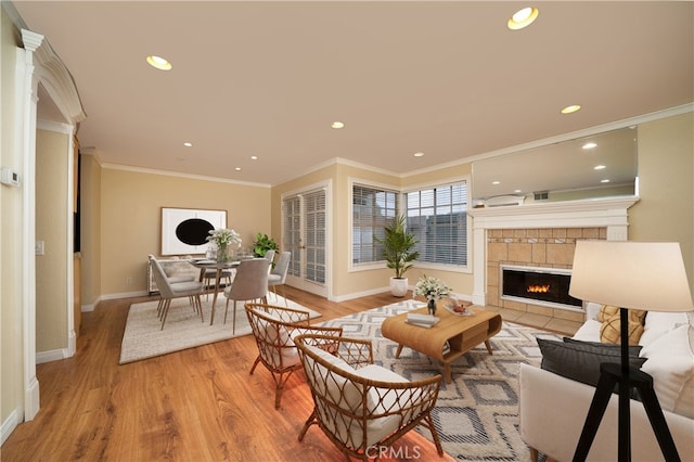 155 Oxford Unit 37, Irvine, CA 92612 - living room featuring baseboards, light wood finished floors, recessed lighting, crown molding, and a fireplace