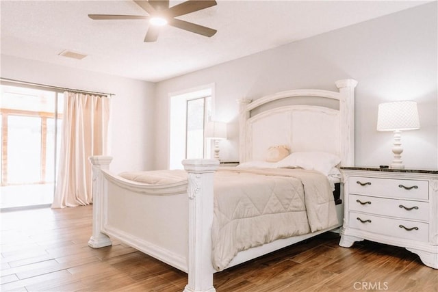 134 N American St, Ridgecrest, CA 93555 - bedroom featuring wood finished floors, multiple windows, ceiling fan, and baseboards