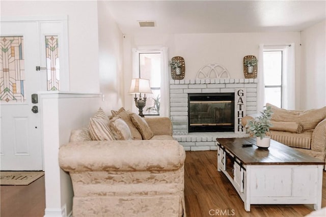134 N American St, Ridgecrest, CA 93555 - living room with dark wood-style flooring and a brick fireplace