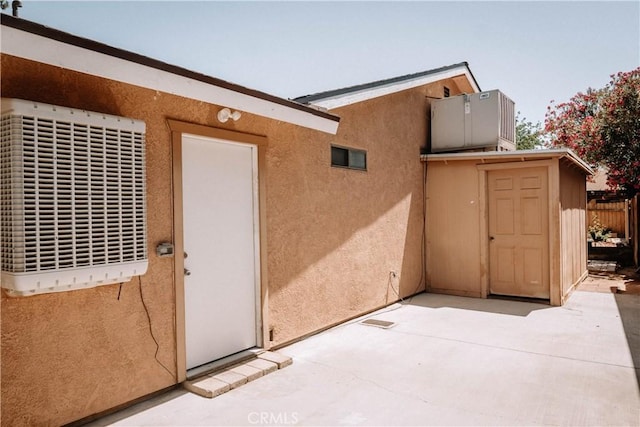 134 N American St, Ridgecrest, CA 93555 - entrance to property with a patio area, stucco siding, and cooling unit