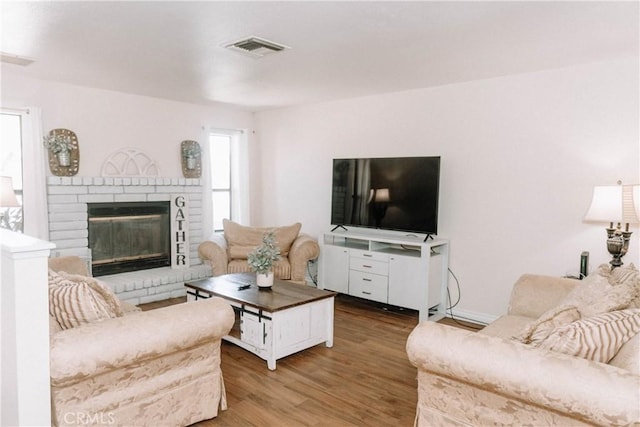 134 N American St, Ridgecrest, CA 93555 - living room with wood finished floors and a fireplace