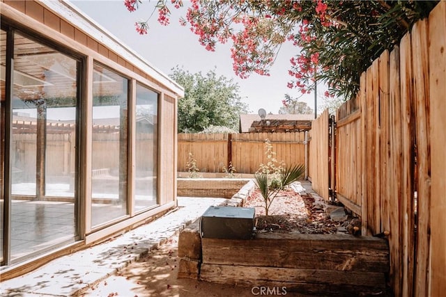 134 N American St, Ridgecrest, CA 93555 - wooden terrace with a fenced backyard and a sunroom