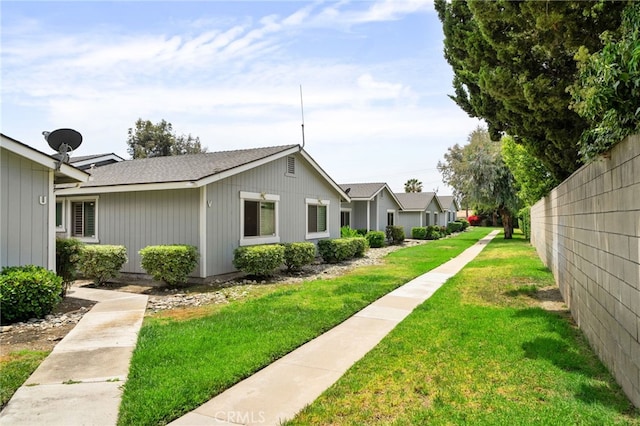 4622 San Jose St Unit W, Montclair, CA 91763 - view of property exterior featuring a lawn and a shingled roof
