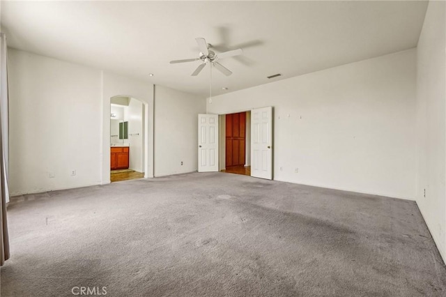 16443 Pine Forest St, Fontana, CA 92336 - unfurnished bedroom with arched walkways, carpet floors, connected bathroom, and ceiling fan