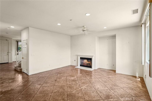 16443 Pine Forest St, Fontana, CA 92336 - unfurnished living room with ceiling fan, recessed lighting, a glass covered fireplace, and stairway