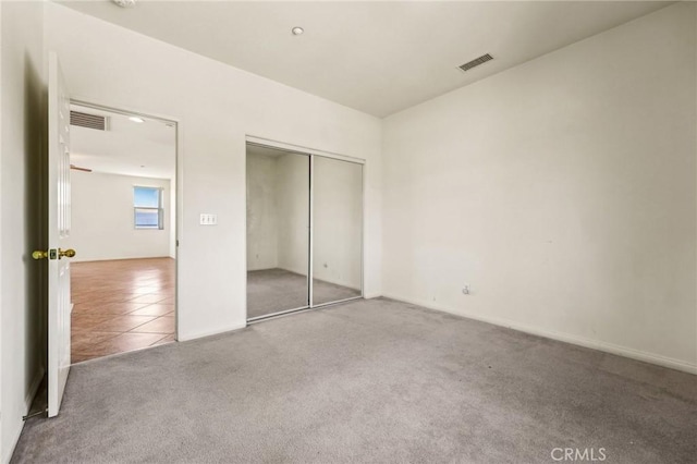 16443 Pine Forest St, Fontana, CA 92336 - unfurnished bedroom featuring carpet, a closet, and tile patterned floors