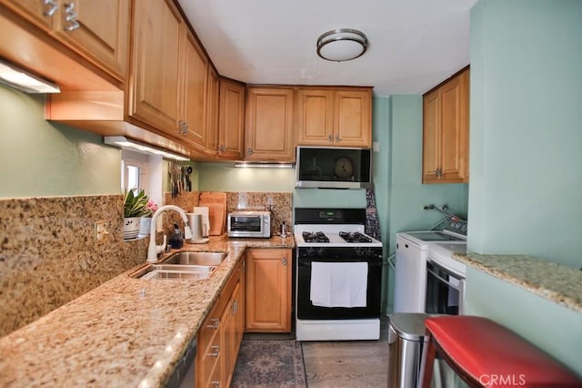 4502 Bates Dr, Yorba Linda, CA 92886 - kitchen featuring gas stove, a sink, washer and clothes dryer, wood finished floors, and light stone countertops